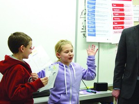 Fort Saskatchewan Chamber of Commerce Executive Director Conal MacMillan (right) helps local kids get their business gears going, as he helped in the Junior Achievement program for elementary students.
Photo by Aaron Taylor/Fort Saskatchewan Record/QMI Agency