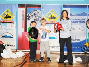 Lori Zacaruk (r) along with Rayden Lether (l) and Justin Bowman (m) demonstrates some of the important things to look for when shopping for a helmet for snowmobile riding during the Alberta Snowmobile Association’s Ride With Respect program at St. Mary School on Jan. 28.
Barry Kerton | Whitecourt Star