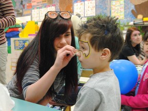 Megan Thibeault helps turn Connor Lefebvre into Batman at the face painting booth at St. Mary School. Thibault was one of the St. Joseph School students who volunteered at St. Mary during their 30th birthday celebrations on Jan. 30.
Barry Kerton | Whitecourt Star