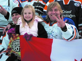 World’s longest hockey game organizer Brent Saik, right, with now wife Jenelle and daughter Angelica celebrate after completing the fourth Guinness Book of World Records bid in 2011 in Strathcona County. Laura Pedersen QMI Agency