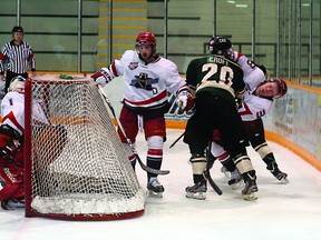 Sherwood Park Crusader Bowen Croft helps to sandwich a Brooks Bandit with a hit behind the net during Saturday’s huge 3-2 overtime victory over the top-ranked Junior A team in the nation. Photo by Trent Wilkie/Sherwood Park News/QMI Agency