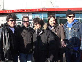 Members of the Tragically Hip, from left, Paul Langlois,  Gord Sinclair, Johnny Fay, Rob Baker and Gord Downie stand in front of the K-Rock Centre on Monday afternoon after Barrack Street in front of the entertainment venue was officially named Tragically Hip Way. The Kingston band is performing for the third time at the K-Rock Centre on Monday evening.
Ian MacAlpine The Whig-Standard