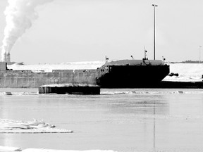A barge sits at the Essar Steel Algoma docks on Monday.