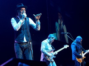 Gord Downie, left, Gord Sinclair and Rob Baker of The Tragically Hip perform at the K-Rock Centre Monday night. (Ian MacAlpine/The Whig-Standard)