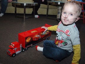 Four-year-old Weslee Brinn shows off one of his favourite toys at his home. Weslee was born with a serious heart condition and requires a transplant. The family will be the beneficiaries of proceeds from a St. Thomas Roadhouse fundraising dinner on Feb. 12. For tickets, contact the Roadhouse at 519-637-2220. (NICK LYPACZEWSKI, Times-Journal)