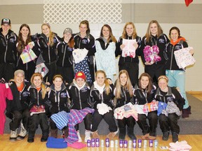The Saugeen Maitland Midget AA Girls Hockey Team collected and donated some
pyjamas and hygiene supplies to the Women’s House of Bruce County and posed with the goods prior to a practice two weeks ago. Pictured back row:  Shea Tiley, Cassidy Colhoun, Ciara Lark, Dawn Pletsch, Kelly Gribbons, Kailyn Soers, Maddie Duncan, Tori Terpstra and Harley Westman. Front Row:  Courtney Surridge, Morgan Baker, Ashlee Lawrence, Miranda Lantz, Jamie Simpson, Sara Biesenthal, Jordyn Sholdice and Lexi Smith.