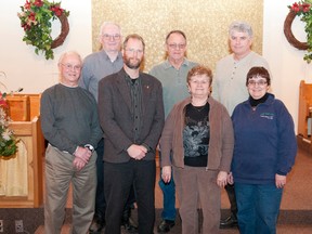 Jim Collins, Doug Cooper, Blaine Stephenson and Norm Eckel, members of the transition team as well as Pastor Colin Snyder and June Cooper and Donna Collins stand at the front of the Brucefield United Church, where congregations from Brucefield, Goshen, Varna and Kippen meet for worship.