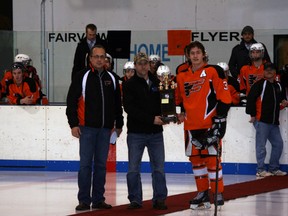 Presentation of The Heart of Flyers Award at the Fairplex arena on Friday, Feb. 1, 2013. The award was inspired by Kelly Pohr, an avid Fairview hockey player who loved the game. Fairview Flyers President Jerry Johnson (left), Kelly's brother Terry (middle) presented the award to MVP Tanner Bjorklund (right).  (Simon Arseneau/Fairview Post)