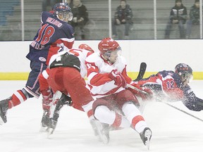 Icemen Suede Omeasoo and Ryley Bennefield collide with a pair of North Edmonton Red Wings during a game at the Civic Centre Feb. 1. The Red Wings went on to win 5-4.