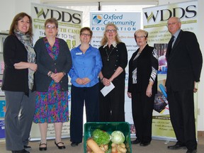 Members of the different agencies involved in the Oxford Garden Fresh Box gathered for the announcement Woodstock and District Developmental Services received a $25,000 from the Oxford Community Foundation to buy much needed equipment needed to grow the program. Left to right, Deb Roloson, WDDS, Nancy Taylor, Flowers of Hope ambassador, Linda Dimock, Woodstock and Area Community Health Centre, Jean Carson, Maple Leaf Foods/Cold Springs, Mary Anne Silverthorn, Oxford Community Foundation, and Bill Semeniuk, president of Oxford Community Foundation. 
TARA BOWIE / SENTINEL-REVIEW / QMI AGENCY