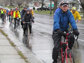 Cycling on city sidewalks with a wheel size larger than 20 inches is prohibited but Coun. Terry Burrell says some cyclists should be able to use sidewalks in designated areas of the city. Cyclists ride in memory of Denis Ross, who was killed in a collision, in this 2011 file photo. OBSERVER PHOTO