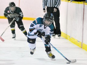 Eddie Chau Simcoe Reformer
Jack Gill of the SImcoe Atom AE Warriors gains control of the puck as he's chased by members of the Pelham Panthers during an OMHA playdown game Tuesday at the Simcoe Recreation Centre.
