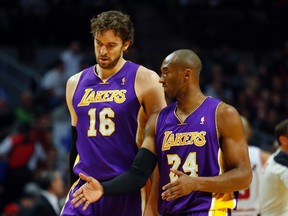 Lakers' Pau Gasol talks with Kobe Bryant. (REUTERS)