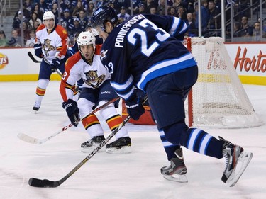 Florida Panthers' Mike Weaver (C) tries to block a shot by Winnipeg Jets' Alexei Ponikarovsky (R) during the second period of their NHL hockey game in Winnipeg February 5, 2013. REUTERS/Fred Greenslade  (CANADA - Tags: SPORT ICE HOCKEY)