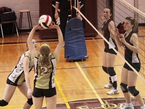 Korah’s Hillary Prouse (2) sets for teammate Danielle Wilding as Knights defenders Kristie Scarfone (top left) and Hannah Murray keep an eye on things as they prepare to go up for the block during action Tuesday.