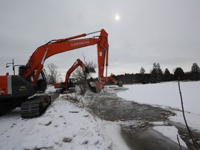 A series of high hoes scoop frazil ice out of the Saugeen River in Durham. The machinery was removed Tuesday afternoon.