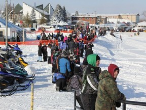 People gathered along the peninsula of Lake Commando to view the snowmobile drag races on Saturday, Feb. 2.