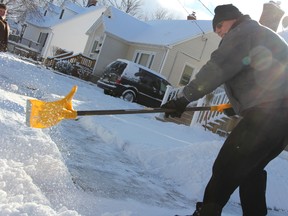 Wellington Street resident Al Metcalfe clears off his driveway in Sarnia, Ont. Thursday, Jan. 24, 2013. About six centimetres of snow blanketed Sarnia-Lambton overnight, according to Environment Canada. BARBARA SIMPSON / THE OBSERVER / QMI AGENCY