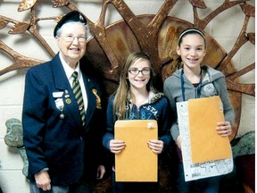 Winners from the Delhi Royal Canadian Legion Remembrance Day poster, poetry and essay contest were recently announced. Legion Youth Education Officer Rose Pettit  recognized the winners from Delhi Public School, Rylie Henderson, winner of the junior black and white poster contest, and Meg Sherman who placed second in the same category. (Contributed photo)