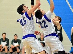 Tim Andrews, left, and Alex Losier, of the TH&VS Blues, battle for a rebound with Skylar Cornell, of the O’Gorman Knights, during NEOAA Central Division senior boys exhibition basketball action at O’Gorman High School. The Blues ran out to a big lead and then held on for a 39-29 victory.