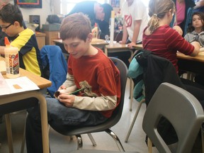 Liam Doyle, 10, works on his model rocket at the Airdrie Space Science Club meeting on Saturday morning.