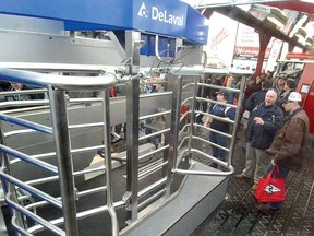 A steady stream of guests checked out cutting-edge technology like this DeLaval milking machine, one of several robotic systems on show at the Canadian Dairy XPO at Stratford Rotary Complex Wednesday. It's distributed by Norwell Dairy Systems Ltd. (SCOTT WISHART The Beacon Herald)