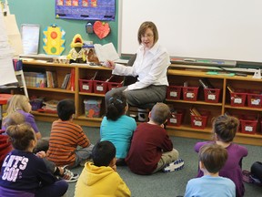 Principal Karen Moran of St. Marguerite Bourgeoys Catholic School reads to a Grade 1 class Wednesday morning. Moran was named one of Canada's Outstanding Principals.
Elliot Ferguson The Whig-Standard