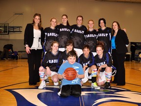 The Sault College women's Cougars basketball team includes: (back row, left to right) Rachel Cobean (assistant coach), Cloe Martella, Chantel Scherbak, Hailey Bomhof, Keisha Giroux, Danielle White and Katie Hamilton (head coach). (front row, left to right) Amy Coulter, Kelsey Greco, Alexandria King and Jaclynne Hamell. Connor Coulter, Hailey Bomhof’s godbrother, in front.