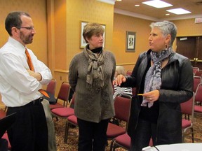 Ed Barlow and Davi Sprenkel of North Star Destination Strategies talk with Sarnia-Lambton resident Michelle Cecchini following a public meeting held at the Holiday Inn, Thursday evening. The company is in town to conduct research as part of a large-scale re-branding project for Sarnia-Lambton. TARA JEFFREY/THE OBSERVER/QMI AGENCY