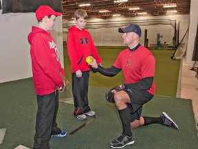 BRIAN THOMPSON, The Expositor

Coach Jay Eberley goes over different grips on the ball with Reece Eberley (left) and Jacob Fischer on Wednesday at the Brantford Minor Baseball Association's indoor training facility at 315 Colborne St. E., the former Union Gas building.