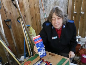 Tess Ayles-Hutt of the Wiarton Salvation Army with some frozen cartons of milk being stored outside the South Bruce Peninsula Food Bank due to a lack of refrigeration and freezer space at facility.