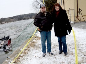 Frankford, ON., residents Dan and Liane Wood are shown here Feb. 7, 2013, near a vehicle submerged in the Trent River. The couple are being hailed as local heroes after saving a 13-year-old girl from the vehicle after it crashed through a fence, flipped over and dove into the freezing cold water around 8:30 p.m. on Feb. 6, 2013. Dan is the pastor at Full Gospel Tabernacle. The pair were finishing up with a church event when the incident occurred. 
EMILY MOUNTNEY/TRENTONIAN/QMI AGENCY