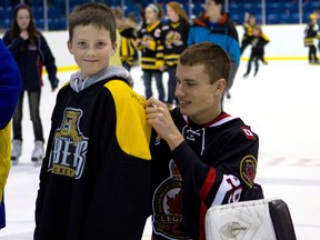 The Sarnia Legionnaires will team up with local minor hockey association groups Saturday for the third annual 'Hockey Day in Sarnia.'. Here, Legionnaire goalie Sean Parker is shown with minor hockey player Conner Post at last year's event. (PHOTO COURTESY OF ANNE TIGWELL)