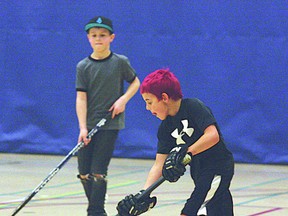 Nine-year-old Ryan Sisson brings the ball up the court in last weekend’s floor hockey fundraiser for the annual Hair Massacure.
Photo by Aaron Taylor/Fort Saskatchewan Record/QMI Agency