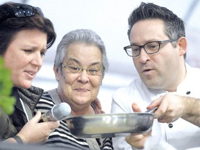 Chef Lynn Crawford, at left, broadcasts the sizzle while fellow chef Jason Bangerter, at right, shows off his gourmet grilled cheese to podium guest Georgina Dean during a cooking demonstration at the Canadian Dairy XPO at Stratford Rotary Complex. (SCOTT WISHART The Beacon Herald)