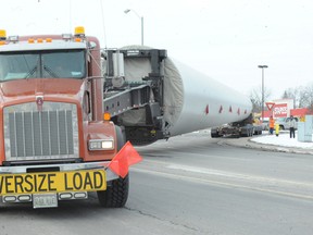 Norfolk OPP interrupted traffic at the intersection of Norfolk Street North and the Queensway Thursday, Feb. 7, 2013 to allow a tractor-trailer carrying a wind turbine tower to make an exceptional turn.   (MONTE SONNENBERG Simcoe Reformer)
