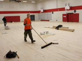 Crews work on the new gym floor of Sir John A Macdonald School on St. Martha Street on Thursday.
Ian MacAlpine The Whig-Standard