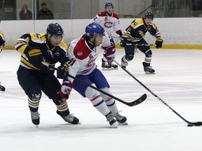 Kingston Voyageurs’ Mike Casale tries to get by Whitby Fury’s Matt Eddy during Ontario Junior Hockey League action at the Invista Centre Thursday night. (Ian MacAlpine/The Whig-Standard)