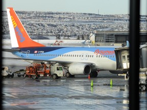 A Sunwing plane sits on the tarmac at the Calgary International Airport in on Jan. 15, 2013. (Stuart Dryden/QMI Agency)