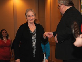 Crime Prevention award recipient Annie Smith, who won an award for her work at GPRC with anti-bullying presentations, makes her way to the stage at Pomeroy Inn and Conference Centre with help from Coun. Kevin O'Toole. Ten people were awarded during Thursday evening, which was the night of recognition. ADAM JACKSON/DAILY HERALD-TRIBUNE/QMI AGENCY