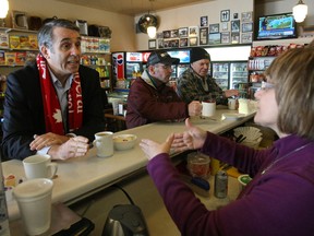 Liberal leader hopeful David Bertschi speaks to Lisa Demarco Friday during a campaign stop at her family's confectionery on Algonquin Avenue.