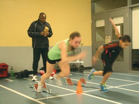 Ricardo Greenidge checks the technique of Airdrie Aces sprinters Julie Noyes, left, and Jalen Greeidge during a recent training session at Genesis Place.
CHRIS SIMNETT/AIRDRIE ECHO