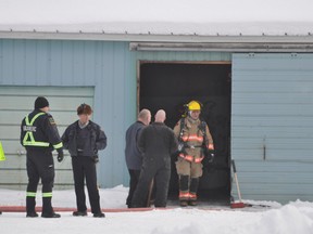 FIrefighters, police and ambulance responded to a small garage fire on Drive Inn Road, about two kilometres north of the Trans-Canada Highway Friday morning. (CLARISE KLASSEN/PORTAGE DAILY GRAPHIC/QMI AGENCY)