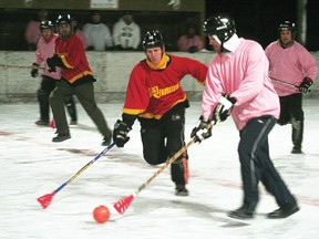 A member of the Pink Pirates tries to brush the ball past a Renovators’ player at Rideout Rink for the Kenora Broomball League. 
GRACE PROTOPAPAS/DAILY MINER AND NEWS