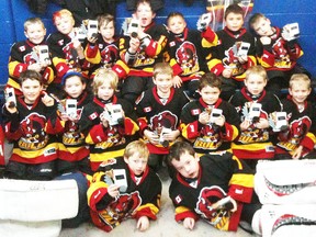 Members of the Kafka and Kort tyke Belleville Junior Bulls celebrate their recent division championship at the Campbellford Canadian Tire tournament. Novices begin playoffs next week.