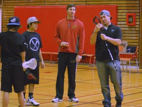 Lacrosse pro Craig Point is about to show teacher Jordan Charter and a pair of Hagersville Secondary School students the finer points of taking a faceoff during the opening class of a new lacrosse-specific phys ed course at the school. (DARRYL G. SMART The Expositor)