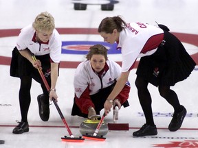 Team Canada skip Colleen Jones throws a rock as third Kim Kelly, left, and second Mary-Anne Arsenault sweep during the final game against Quebec at the Scott Tournament of Hearts in Red Deer, Alta., in February 2004. Five years after the former Canadian and world championship team broke up, Jones, Kelly and Arsenault are back together and will represent Nova Scotia at the Tournament of Hearts women’s curling championship at the K-Rock Centre, Feb. 16-24. (QMI Agency file photo)