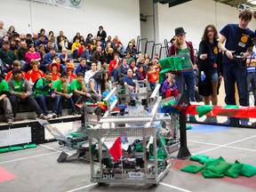 (left) Ashley Reiter of team 1505 and Momlina Evdusy, Paul Poirier and Joschkat McLeod of team 1053 compete in the Vex Robotics Challaenge that was held at Holy Cross Secondary School in St. Catharines on Feb. 9, 2013.