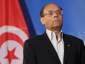 Tunisia's President Moncef Marzouki listens his national anthem at the European Parliament in Strasbourg, February 6, 2013.  REUTERS/Jean-Marc Loos