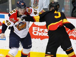 Belleville Bulls defenceman Adam Bignell squares-off in a first-period fight with Erie's Luke Cairns during 4-1 Belleville victory Saturday night at Yardmen Arena. (Jerome Lessard/The Intelligencer.)